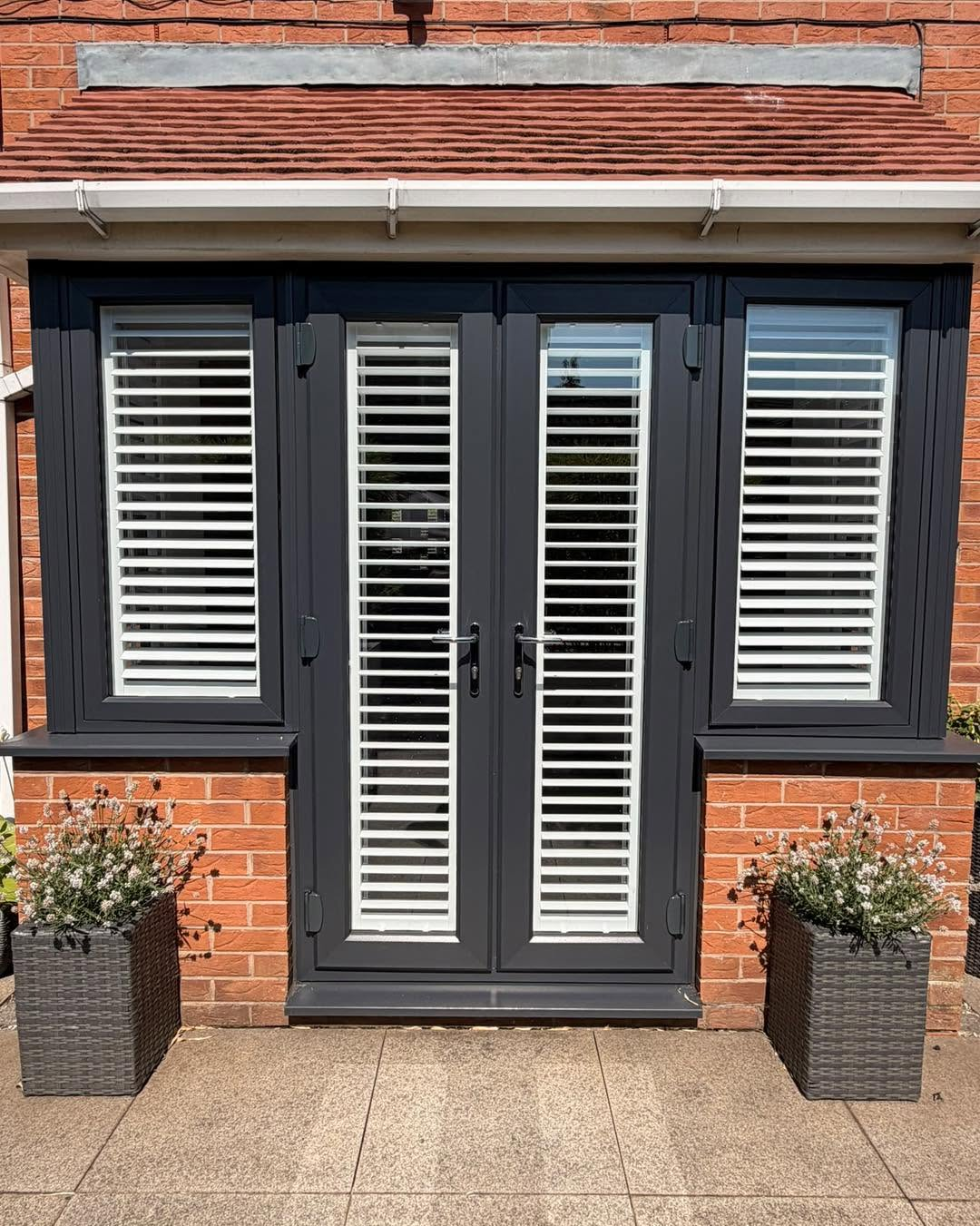 White shutters fitted to anthracite French doors and windows