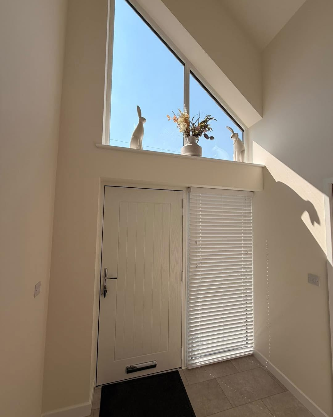 White wooden venetian blind on front door